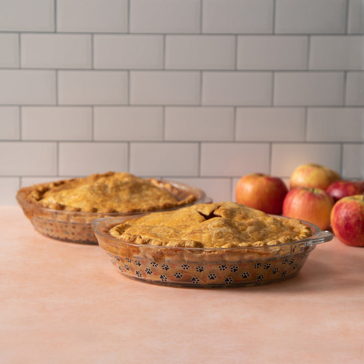 Amber-tinted glass pie plate with paw-print pattern and scalloped rim