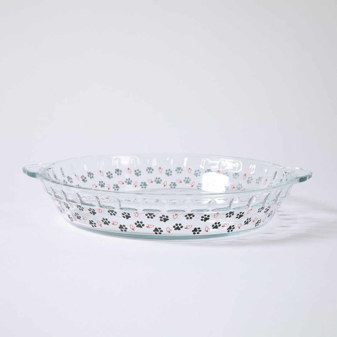Clear glass pie plate with paw prints and hearts along the sides