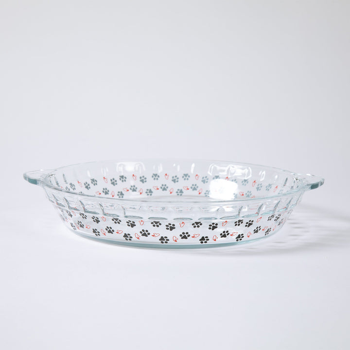 Clear glass pie plate with paw prints and hearts along the sides