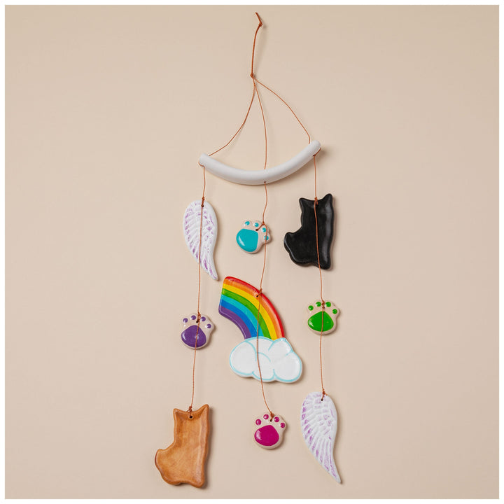 Ceramic pet memorial wind chime featuring rainbow, cloud, wings, and orange cat charm