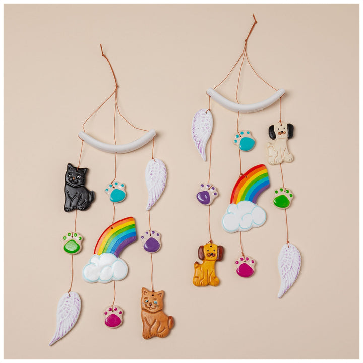 Ceramic pet memorial wind chime with rainbow, cloud, wing charms, and cat and paw details