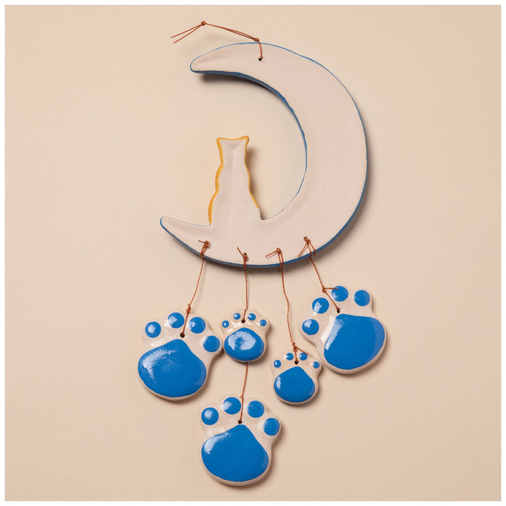 Ceramic moon wind chime with white-and-blue paw ornaments and a gold cat center charm