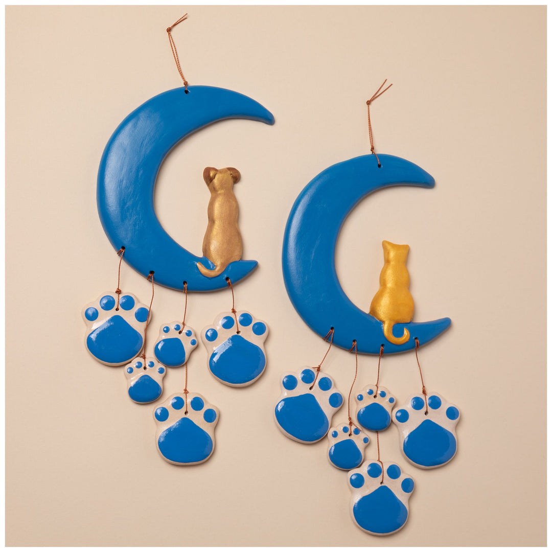 Ceramic moon wind chime with blue paw prints and a small cat-shaped center charm
