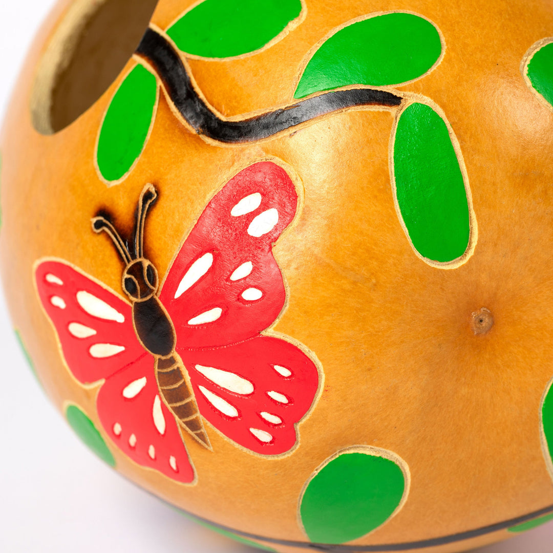 Hand-painted gourd birdhouse with red butterfly and green leaf cutouts