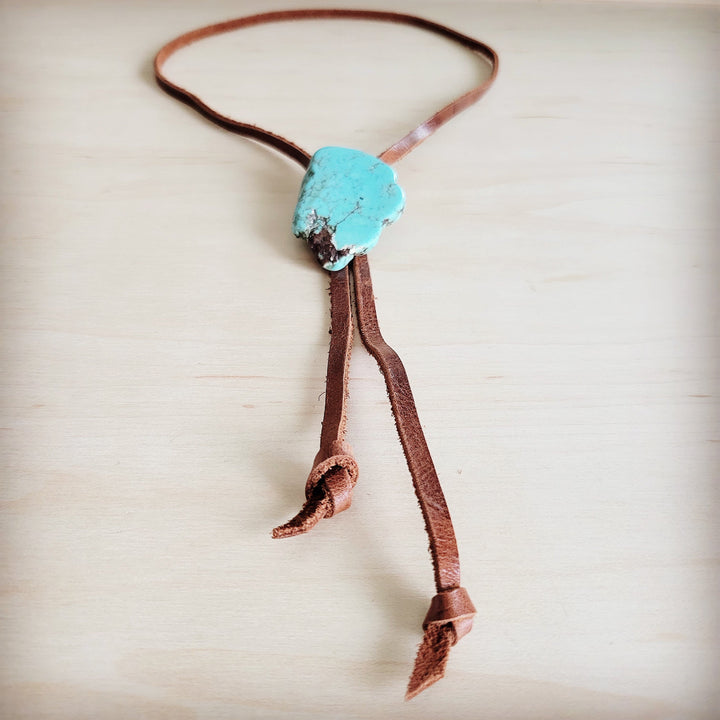 Brown leather lariat necklace with turquoise slab pendant and long tied tassels