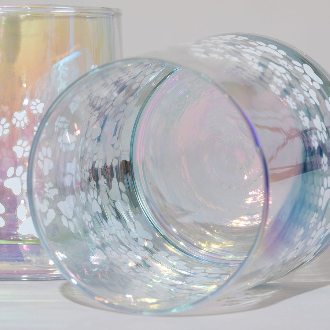 Close-up of iridescent glass candle holders with white paw-print pattern