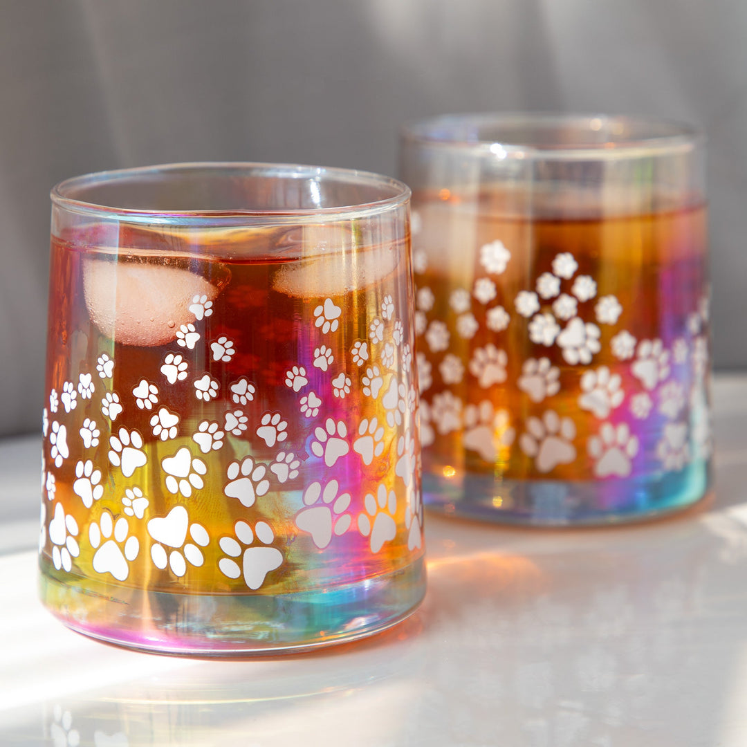 Iridescent glass candle holders with white paw-print decals, amber wax, two cups