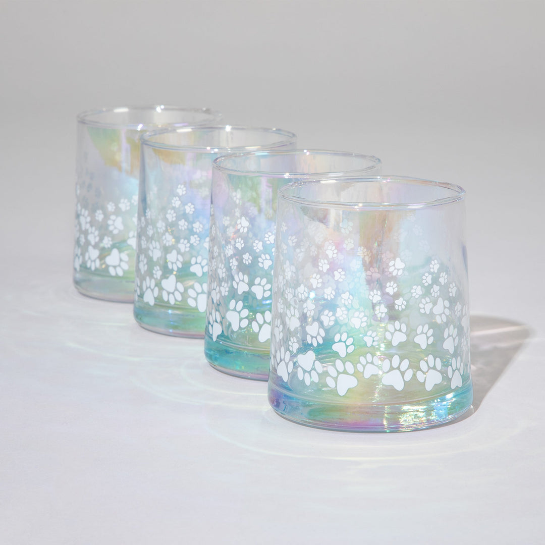 Set of 4 iridescent glass candle holders with white paw-print decals on blue glass
