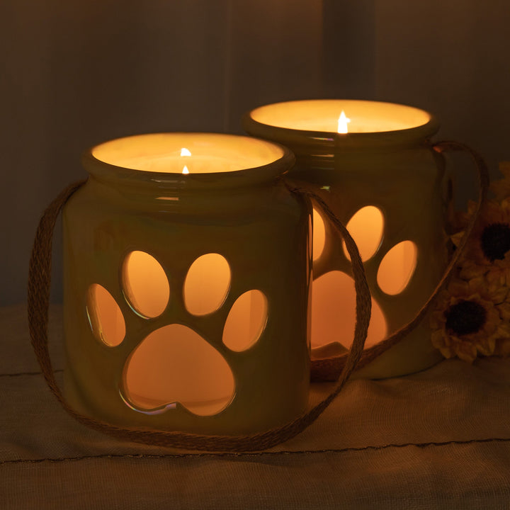 Yellow paw-print glass candle holder set with lit candles and rope handles