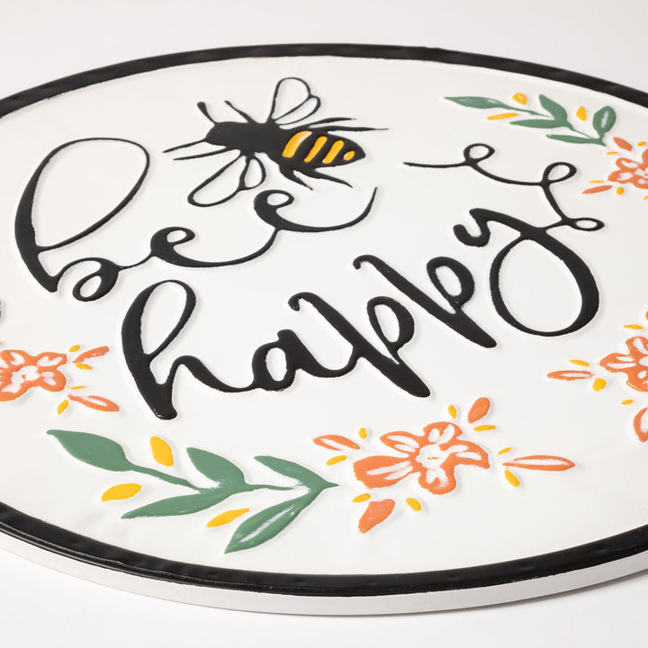 Round wall plaque close-up with bee and &