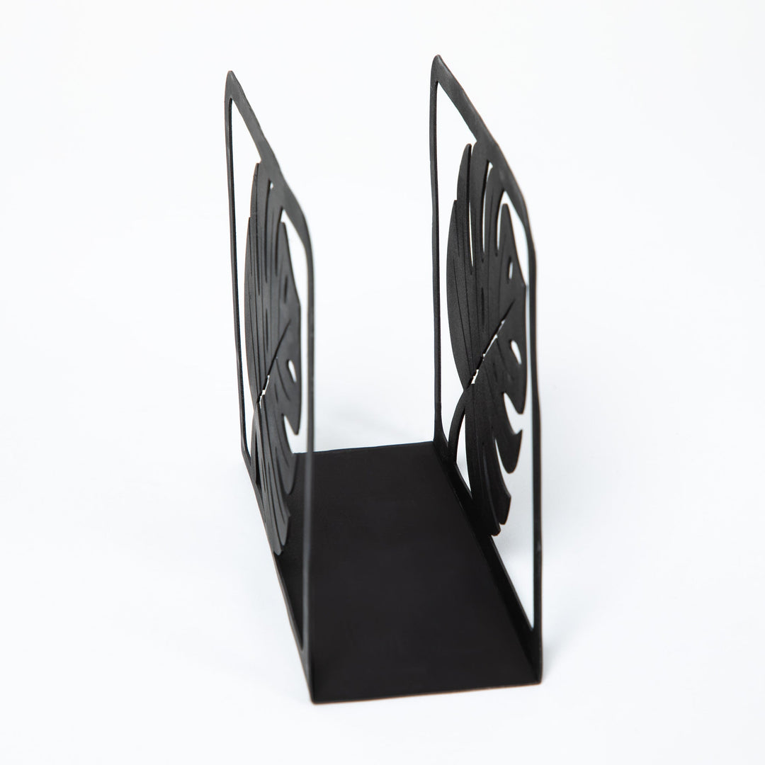 Black metal napkin holder stand with openwork monstera leaf sides