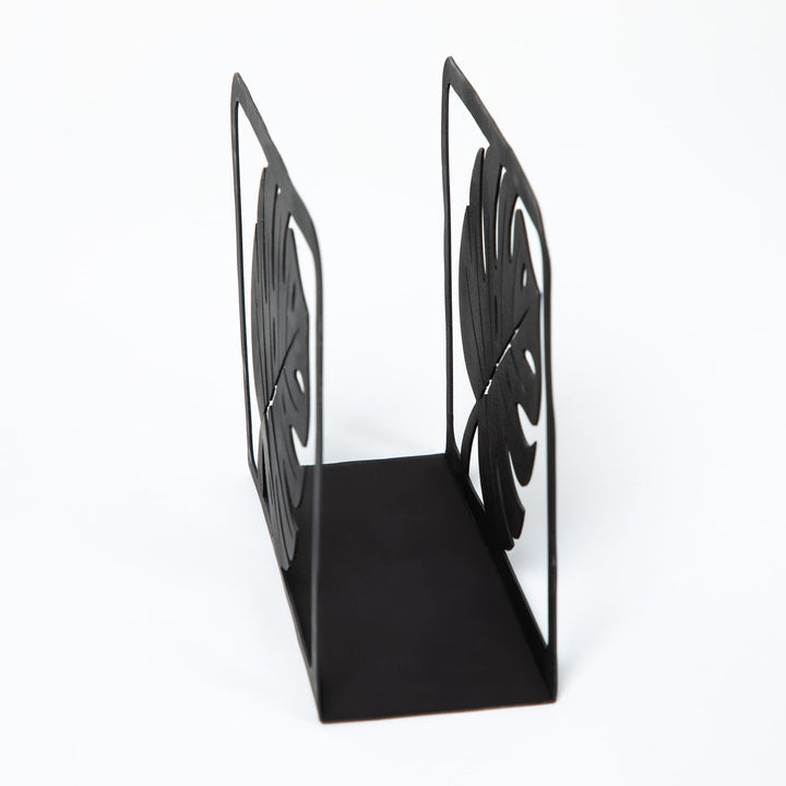 Black metal napkin holder stand with openwork monstera leaf sides