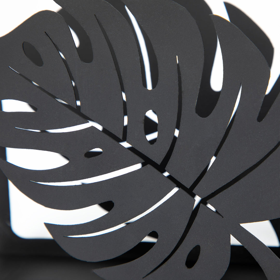 Close-up of black monstera leaf cutout metal napkin holder