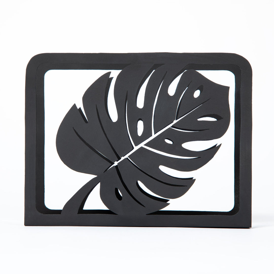 Black Monstera napkin holder with framed leaf cutout design