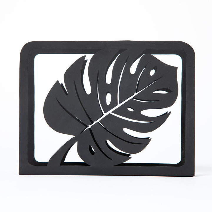 Black Monstera napkin holder with framed leaf cutout design