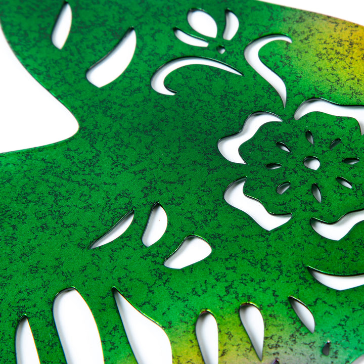 Close-up of iridescent green metal hummingbird silhouette with white cutout details