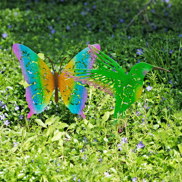 Colorful butterfly garden silhouette stakes with metal wire legs in a flower bed