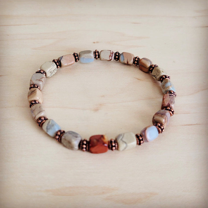 Stretch beaded bracelet with aqua beads, copper centerpiece bead, and dark spacers