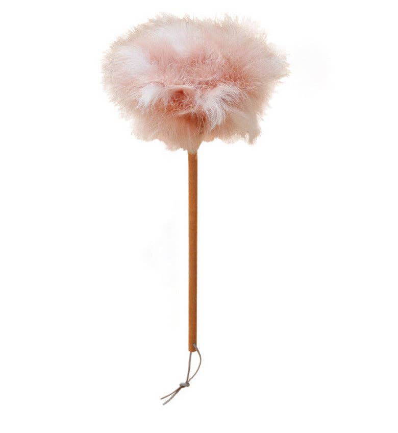 Pink ostrich feather duster with fluffy round plume head and wooden handle with loop tie