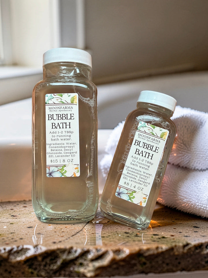 Bubble bath bottles with white caps and BUBBLE BATH labels, with folded bath towel