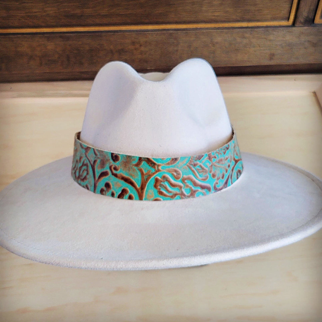 Turquoise leather cowboy hat band with embossed swirl pattern around hat