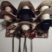Wall-hanging hat organizer with assorted neutral and dark caps hanging on hooks