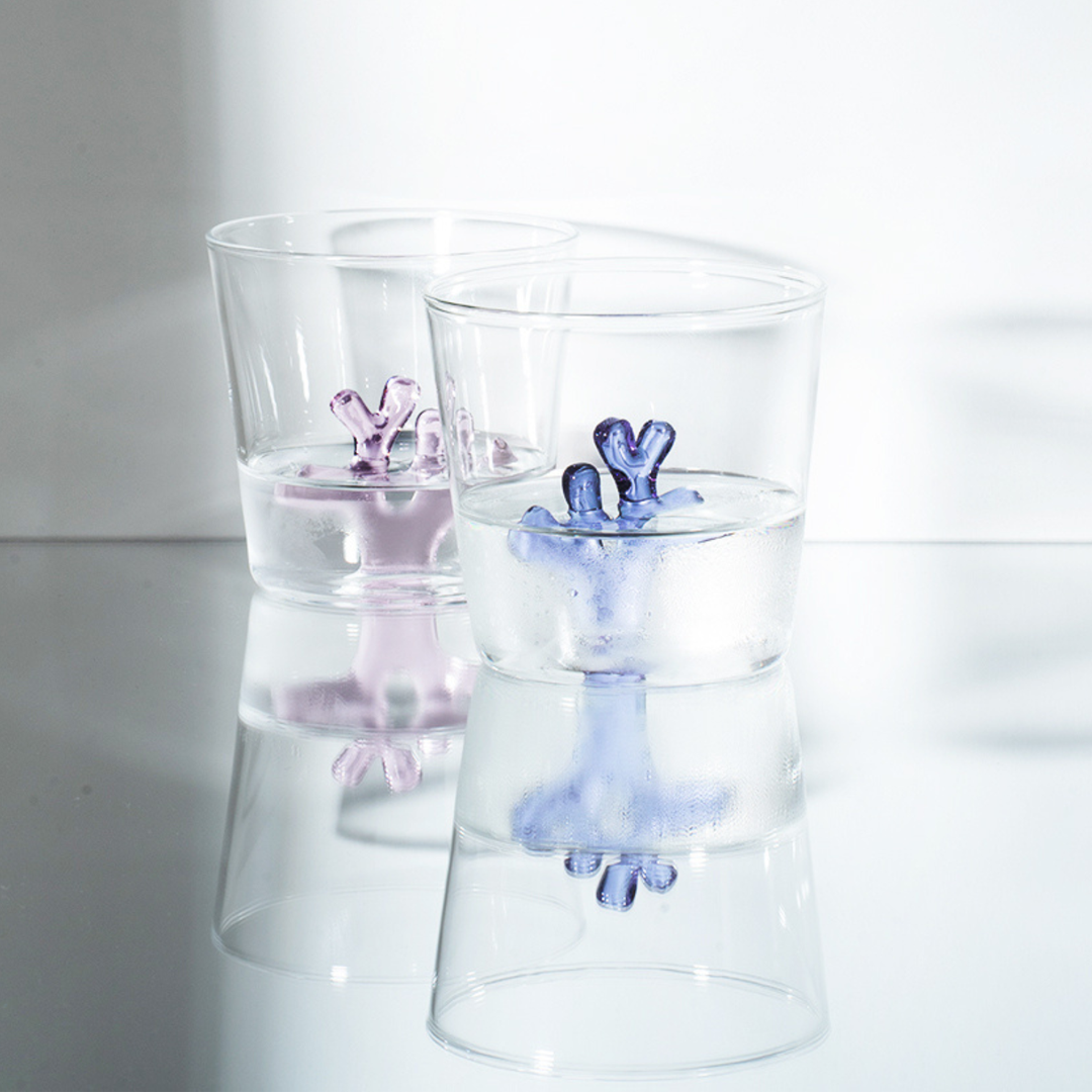 Set of clear glass water tumblers with blue and pink coral inserts
