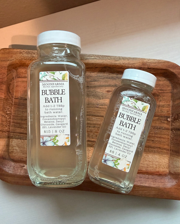 Bubble bath bottles with white caps and BUBBLE BATH labels, clear container pair