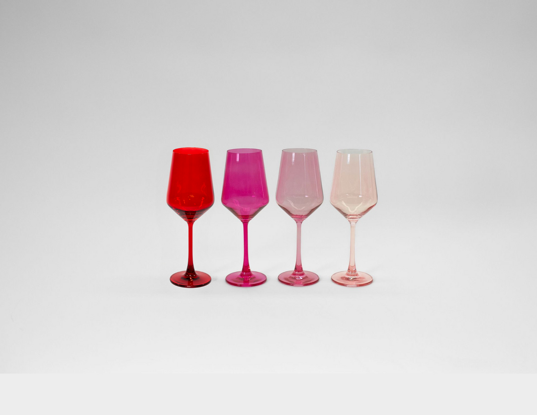 Set of four stemmed ombre wine glasses in red, pink, blush, and clear tones
