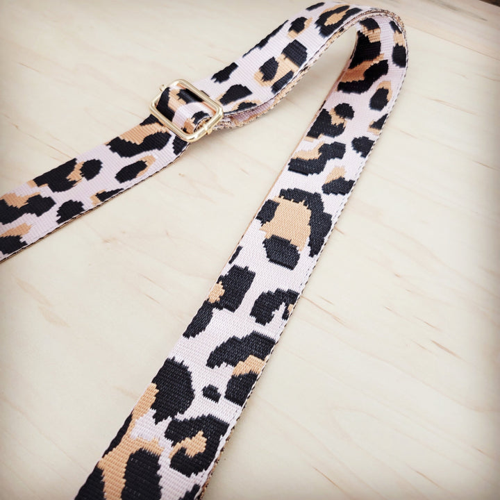 Leopard-print nylon strap with adjustable buckle hardware and stitched edges