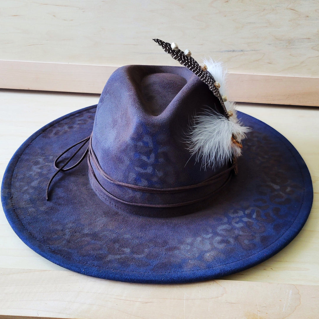 Navy blue leopard-print felt cowgirl hat with feather and jeweled band