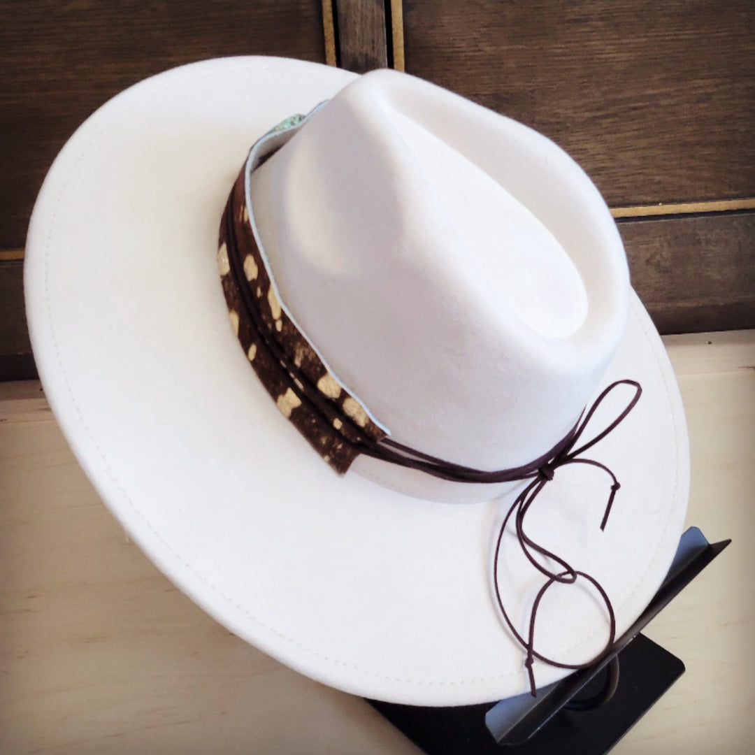 White felt hat with cowhide leather band and turquoise ornament, top-side view