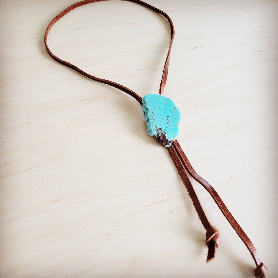 Turquoise slab accent on brown leather lariat necklace with two cord tails