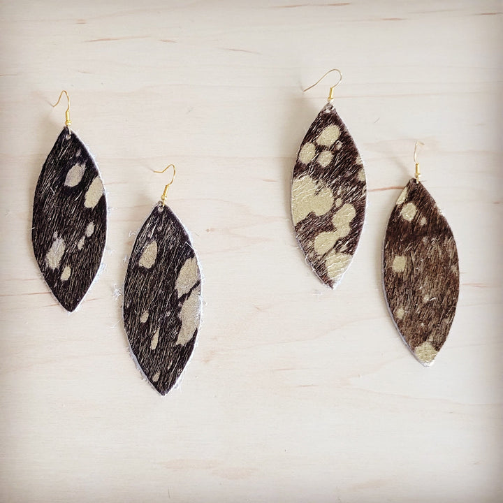 Hair-on-hide oval drop earrings with gold hooks, multiple black, white, and brown patterns