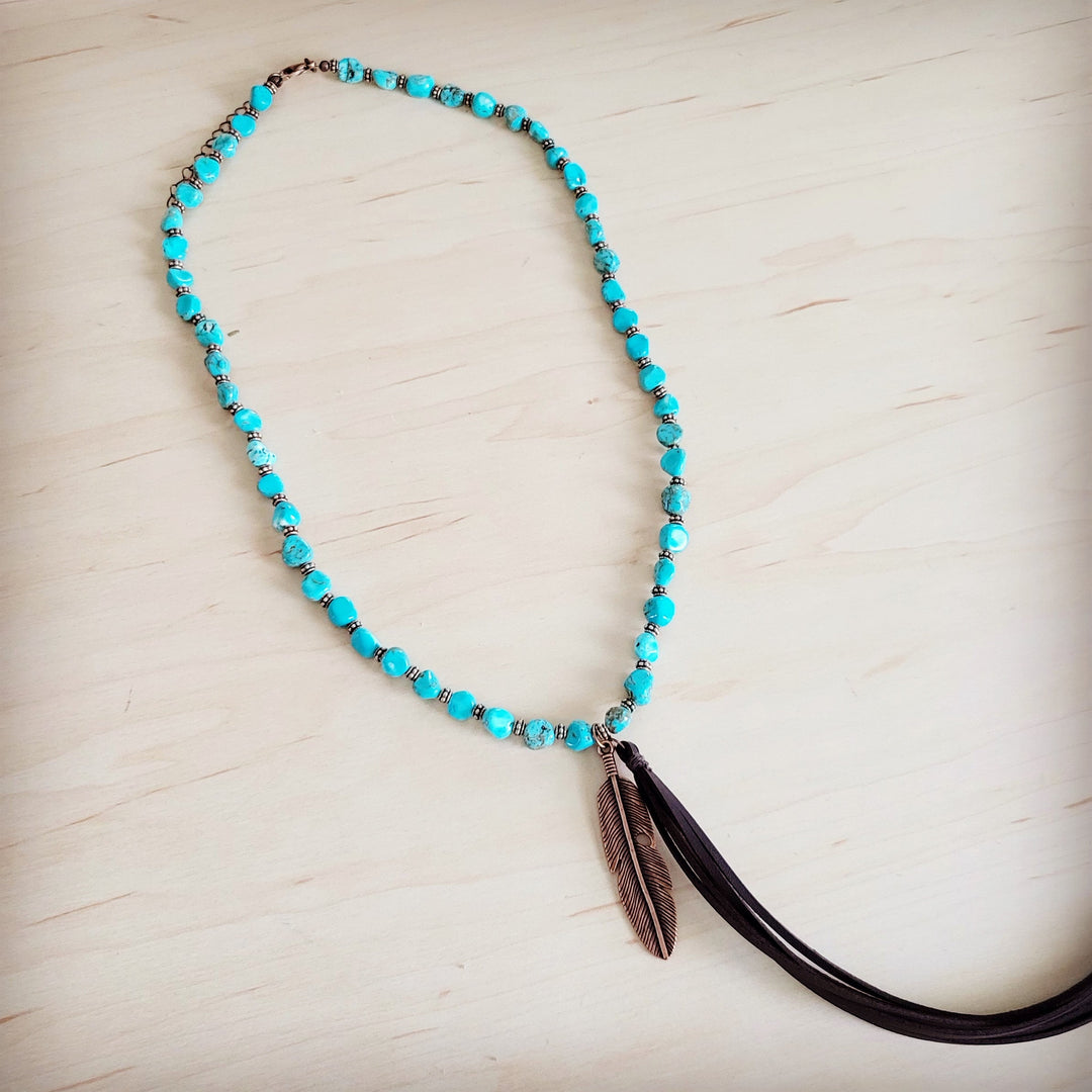 Turquoise beaded necklace with feather tassel pendant and dark leather cord