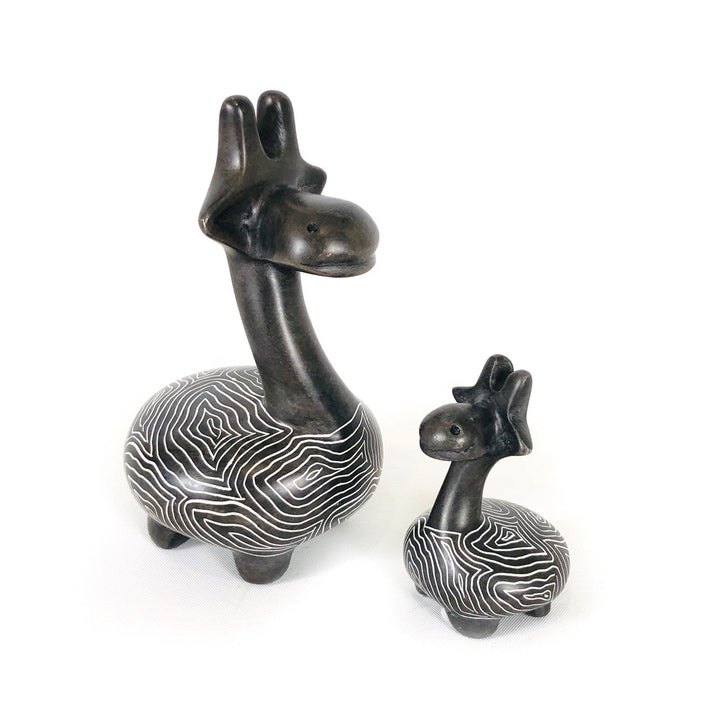 Soapstone giraffe figurines set with dark bodies and white wavy stripe pattern