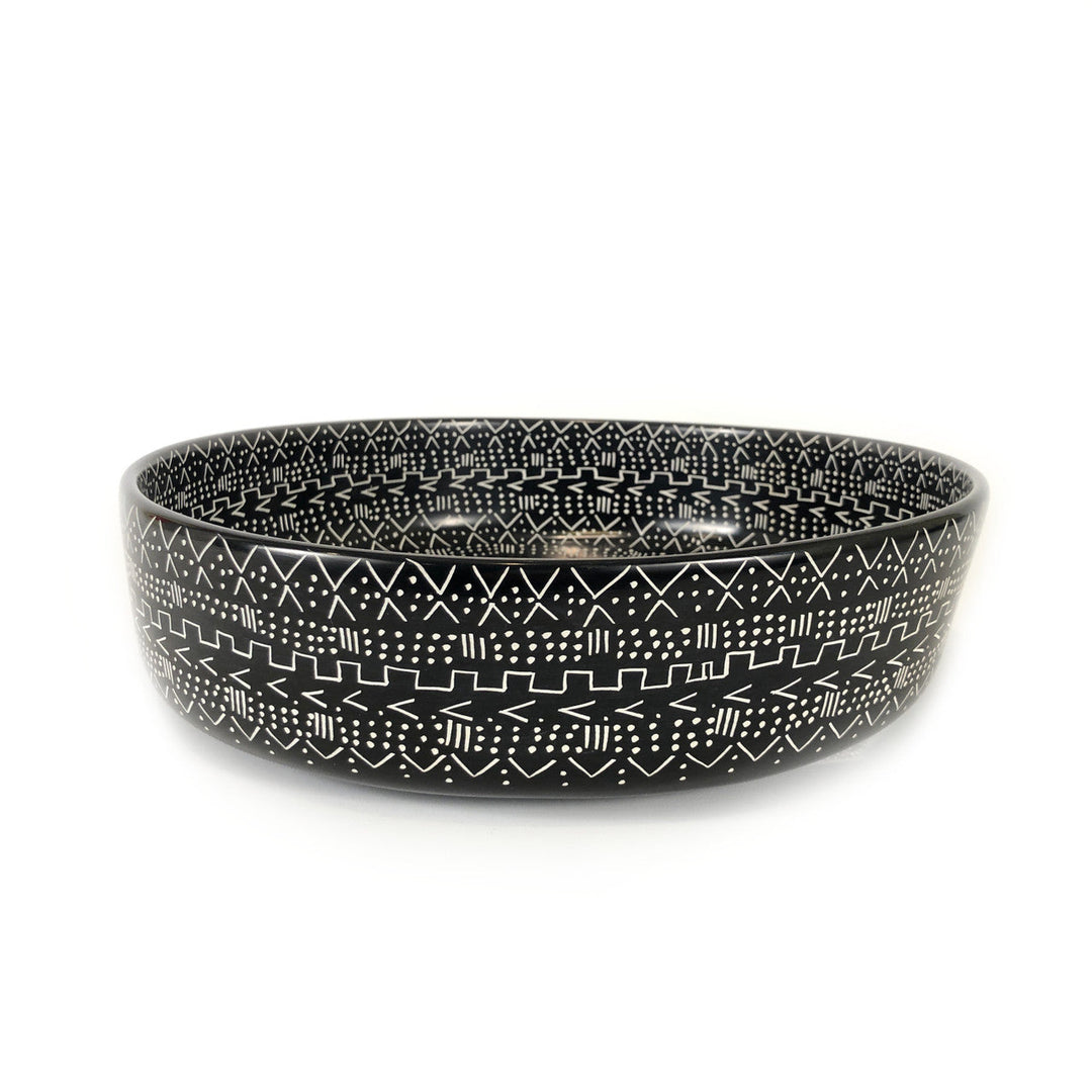 Black mud cloth style bowl with raised rim and white geometric band