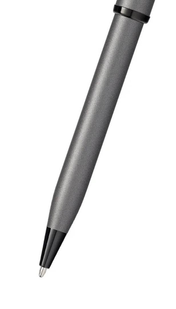 Gunmetal gray ballpoint pen close-up with black tip and textured grip section