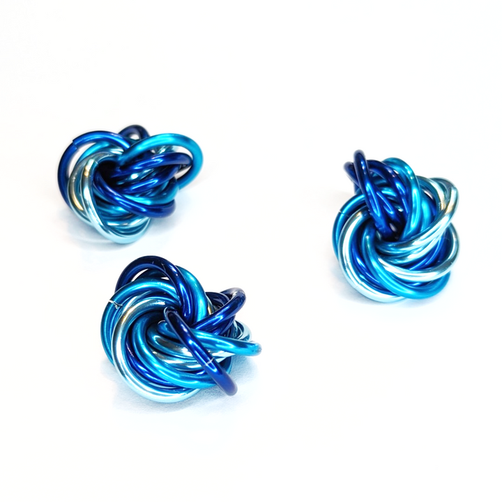 Möbii fidget balls, three blue metallic Möbius rings