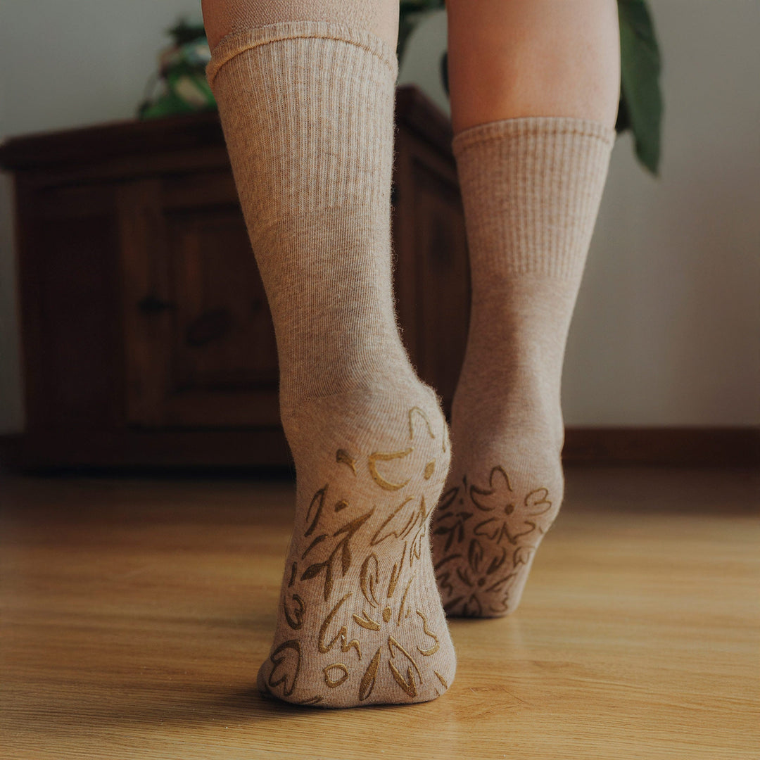 Pair of brown crew socks with non-slip grip pattern on the sole
