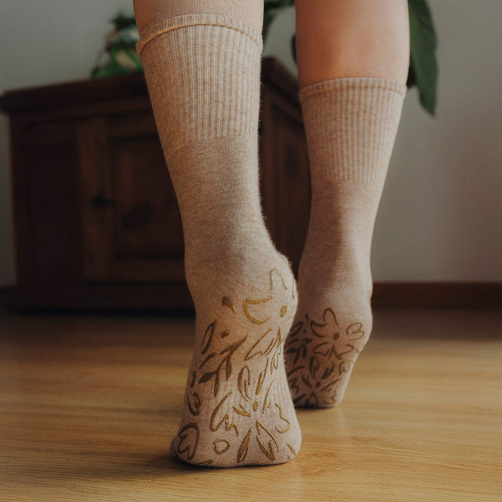 Pair of brown crew socks with non-slip grip pattern on the sole
