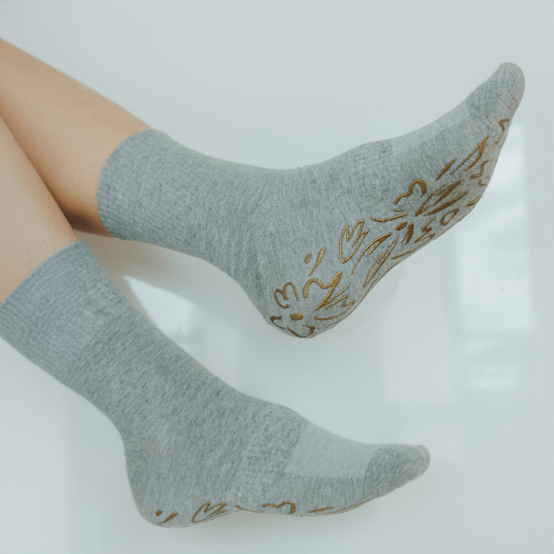 Grey crew socks with gold floral non-slip grip at heel and forefoot