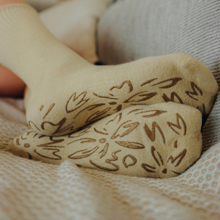 Lemon-beige non-slip socks with brown grip pattern on the foot