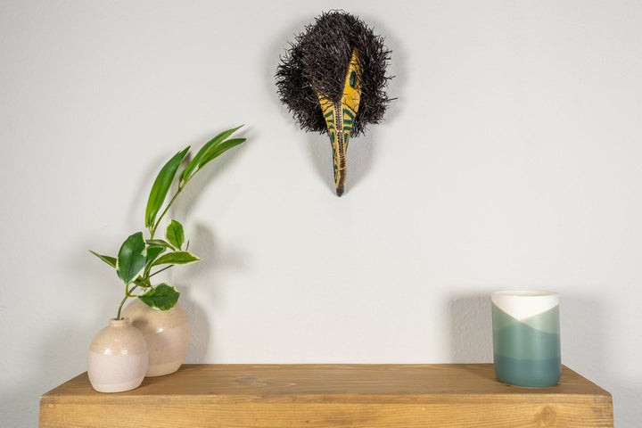 Small toucan mask with black shag texture and yellow-and-green embroidered beak