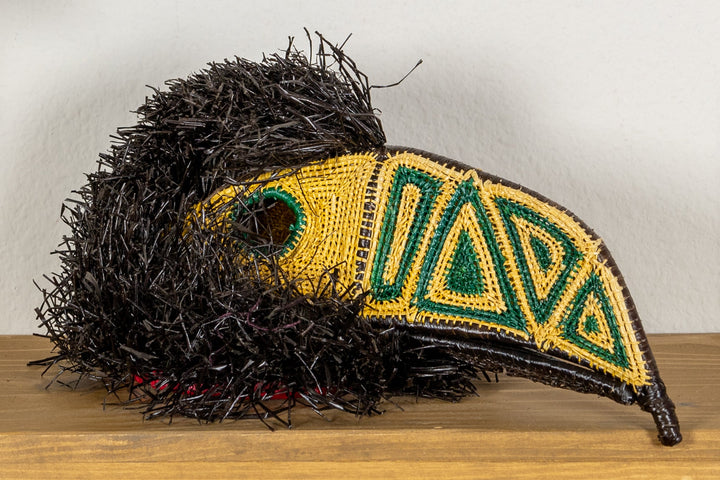 Toucan beak mask with black shag body and yellow-green embroidered wing panel