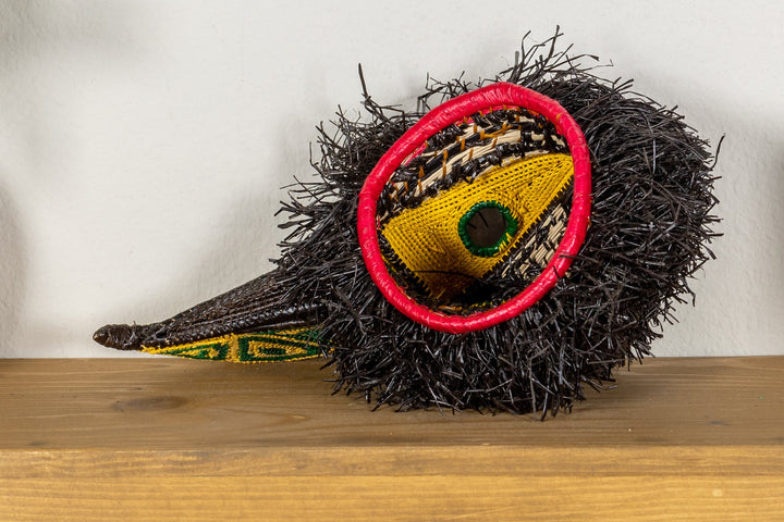 Toucan mask with black fringe, yellow eye patch, and red rim