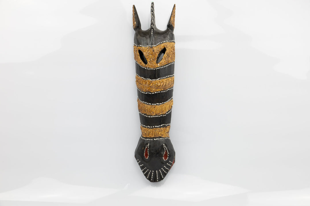 Giraffe wooden wall mask with black body, gold stripes, and carved face details