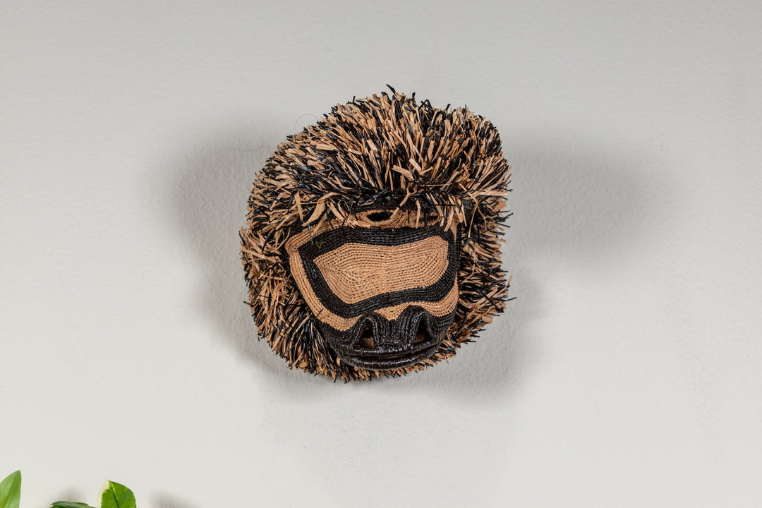 Spider monkey face mask shown from above with brown fringe and dark stitched markings