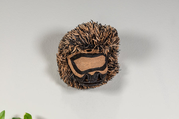 Spider monkey face mask shown from above with brown fringe and dark stitched markings