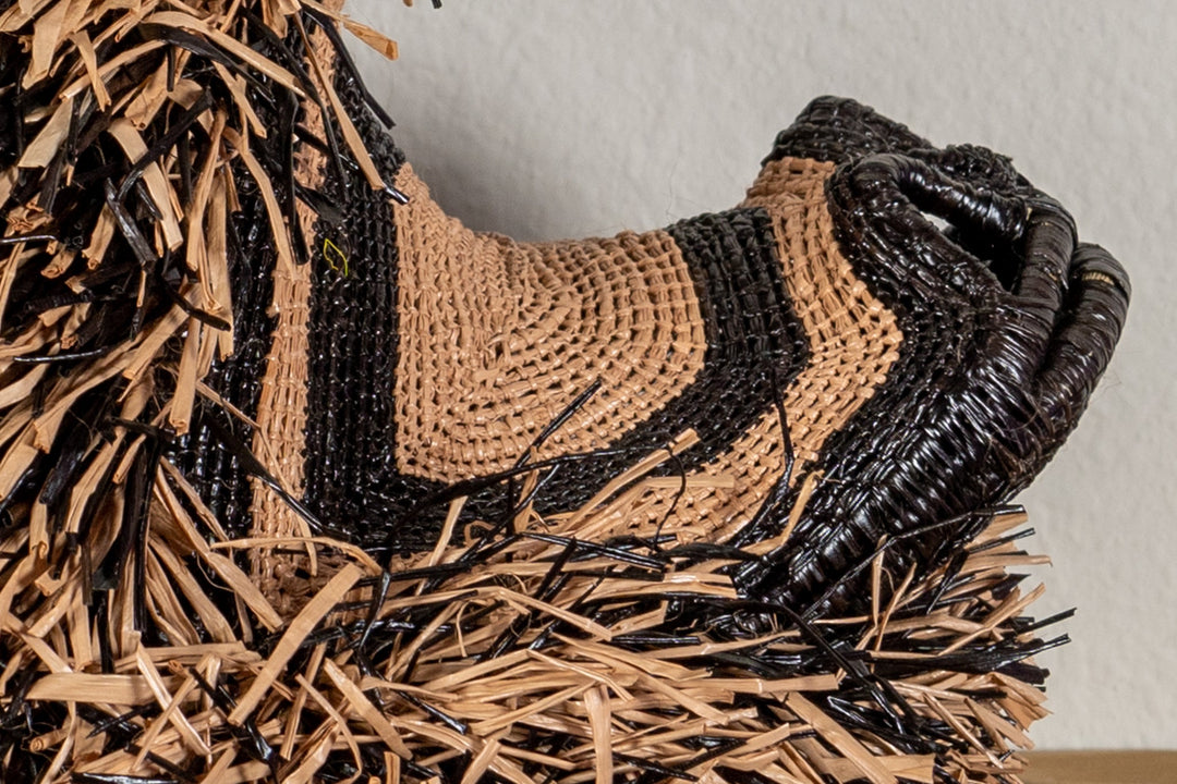 Spider monkey face mask close-up, featuring black trim and brown-and-tan stitched panels